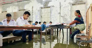 জলাবদ্ধতায় ডুবলো কেন্দ্র: বেঞ্চে পা তুলে পরীক্ষা দিলেন পরীক্ষার্থীরা